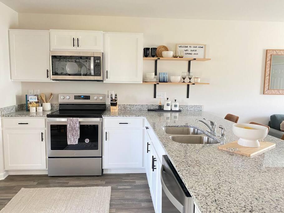 a kitchen with white cabinets and a stove and a sink at New!!! Boiling spring - luxury home sleeps 6 in Inman
