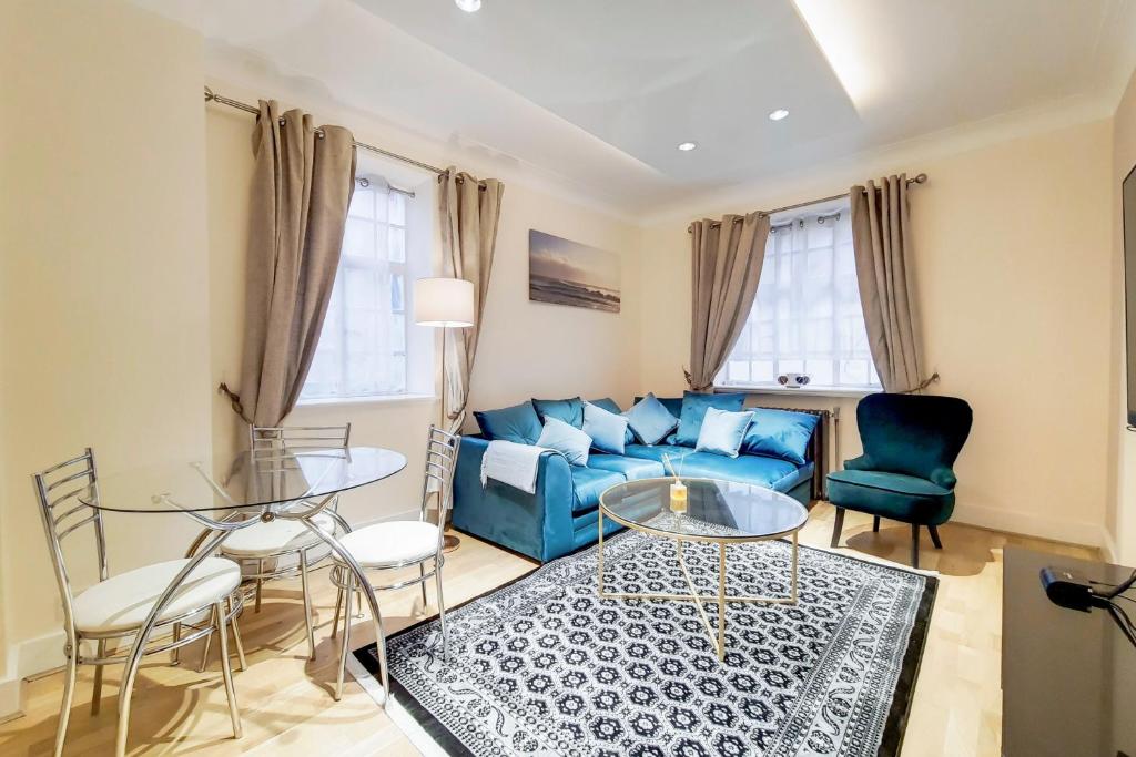 a living room with a blue couch and chairs at The Quebec Boutique in London