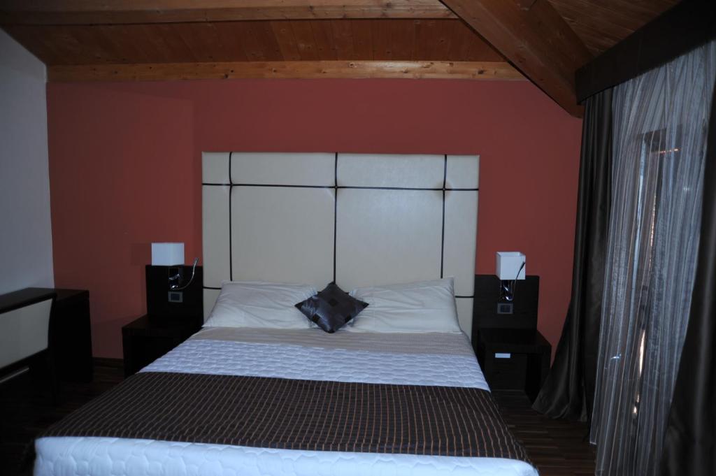 Postel nebo postele na pokoji v ubytování Albergo Minuetto