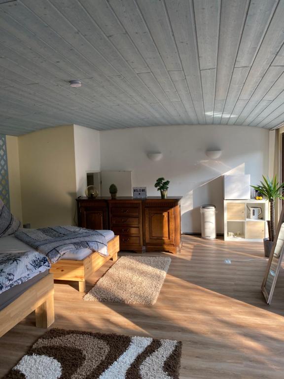 a bedroom with two beds and a wooden ceiling at Gästezimmer am Waldrand in Leimbach