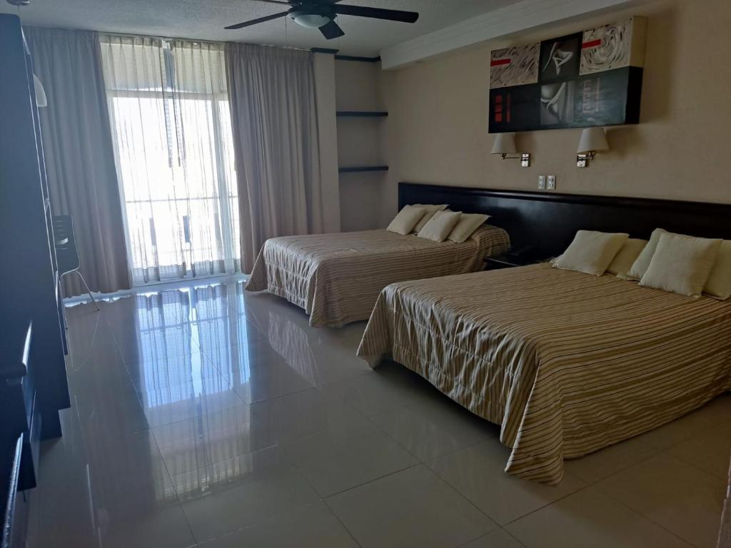 Postel nebo postele na pokoji v ubytování Hotel Mary Celaya