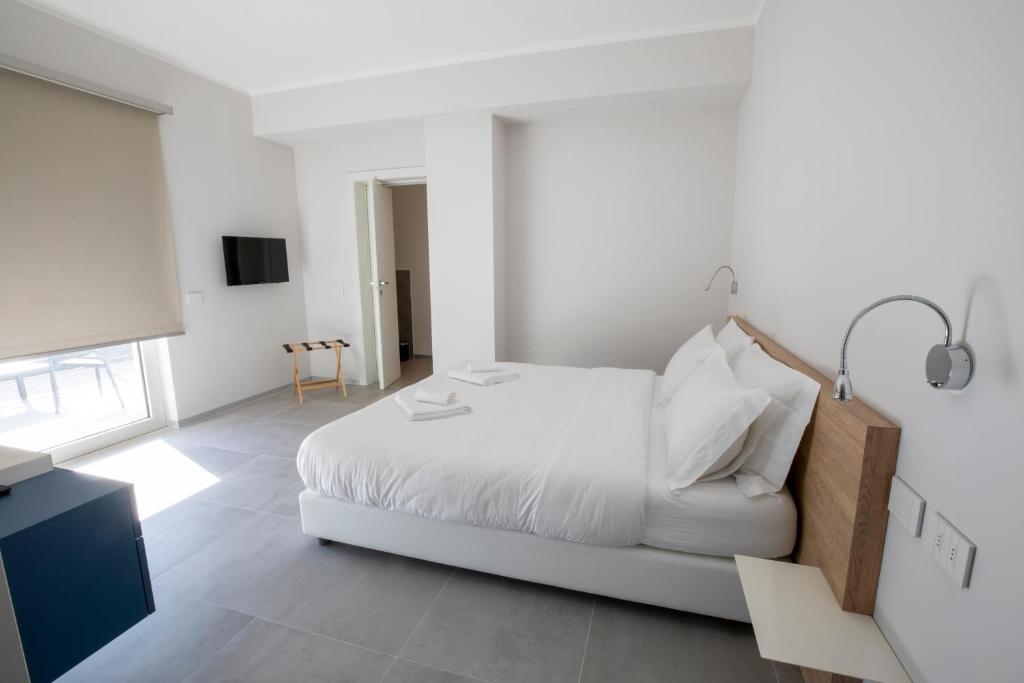 Postel nebo postele na pokoji v ubytování B&B Fior di Magnolia