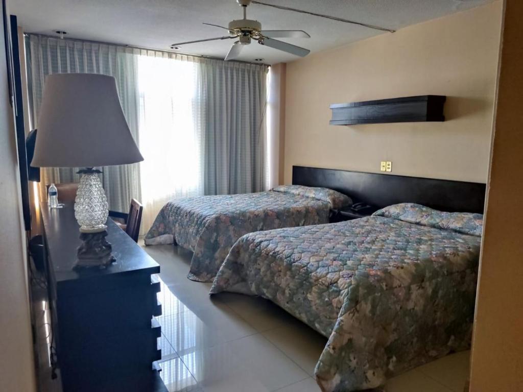 Postel nebo postele na pokoji v ubytování Hotel Mary Celaya