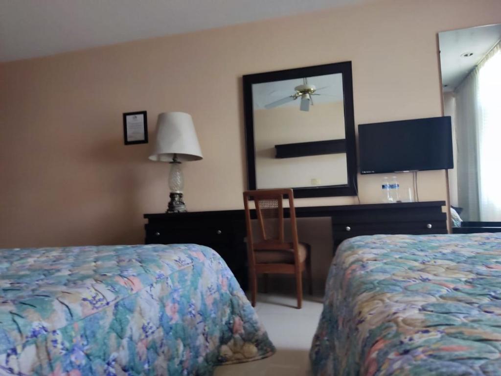 Postel nebo postele na pokoji v ubytování Hotel Mary Celaya