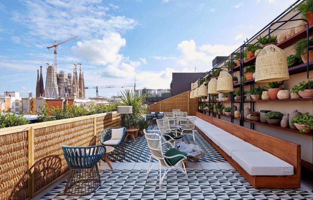 a balcony with chairs and tables on a building at Radisson Blu 1882 Hotel, Barcelona Sagrada Familia in Barcelona