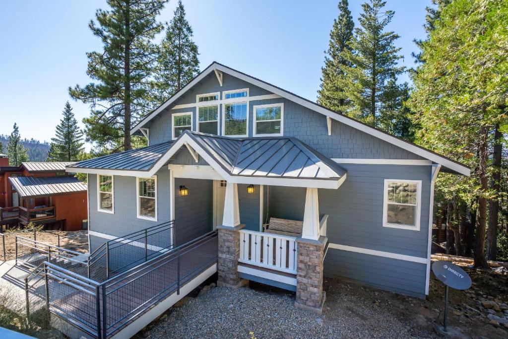 a tiny house with a porch and a deck at El Capitan Loft in Yosemite West