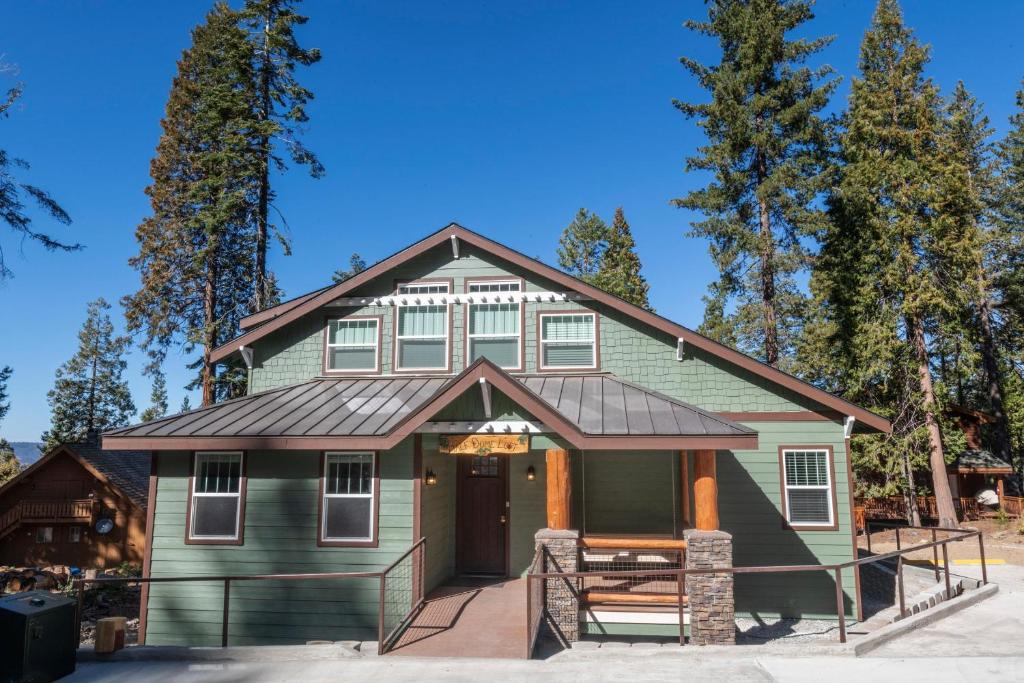a green house with a brown roof at Half Dome Loft in Yosemite West