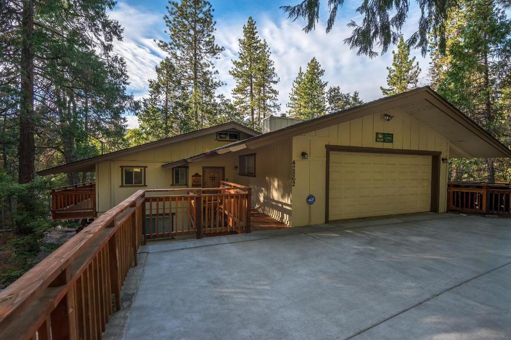 a house with a garage and a fence at Sierra Springs in Oakhurst