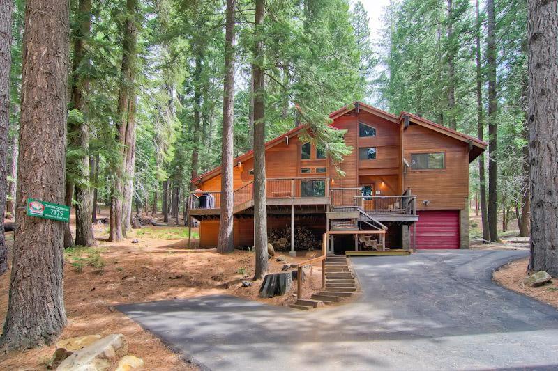 a large wooden house in the middle of a forest at Yosemite Crossroads in Yosemite West