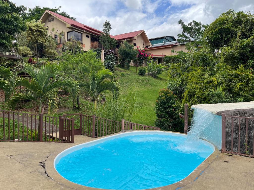 a large blue swimming pool with a water fall at Legacy Boutique Hotel in Quesada