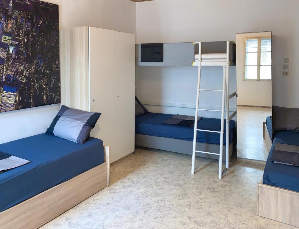 a bedroom with two bunk beds and a ladder at Santoria Casa in Koper