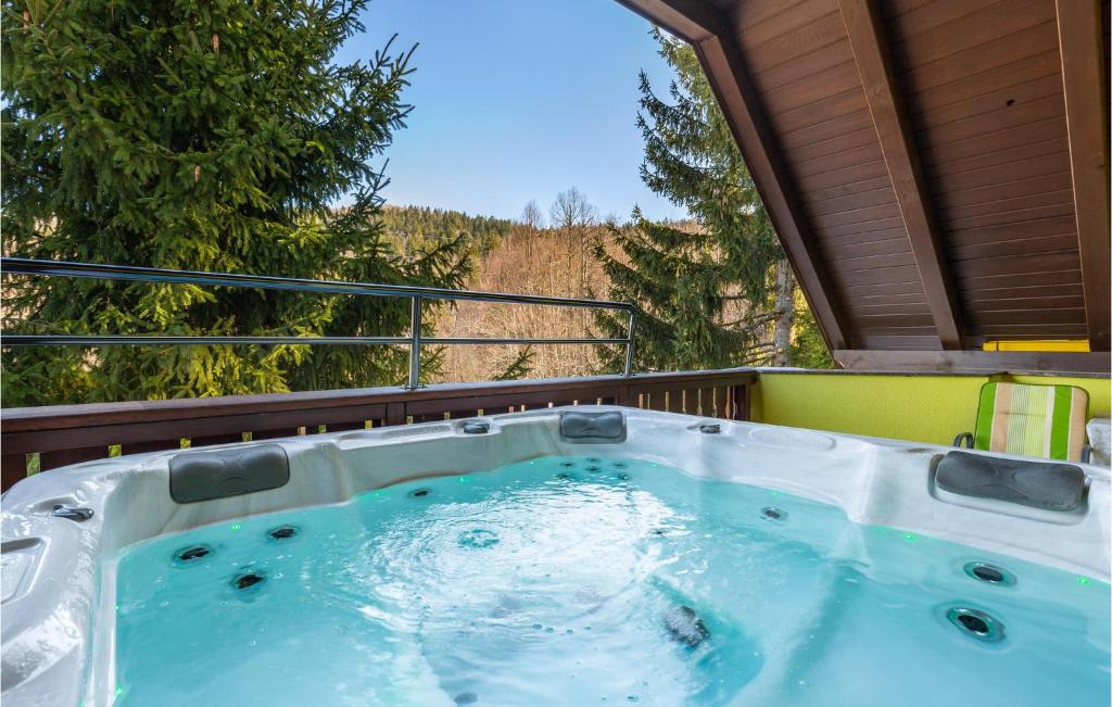 a hot tub on the back of a house at Cozy Home In Lokve With Jacuzzi in Lokve