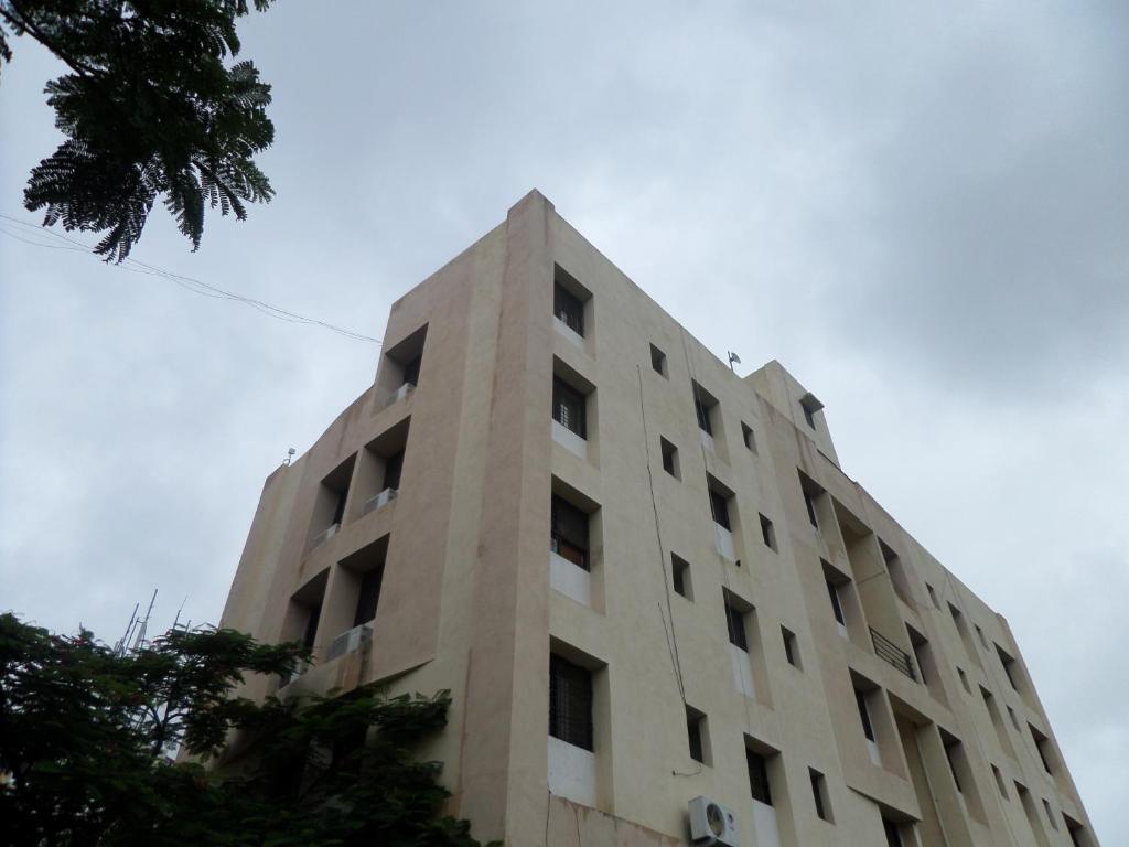 a tall building with the top of it at Cosmos Luxury Vimannagar in Pune