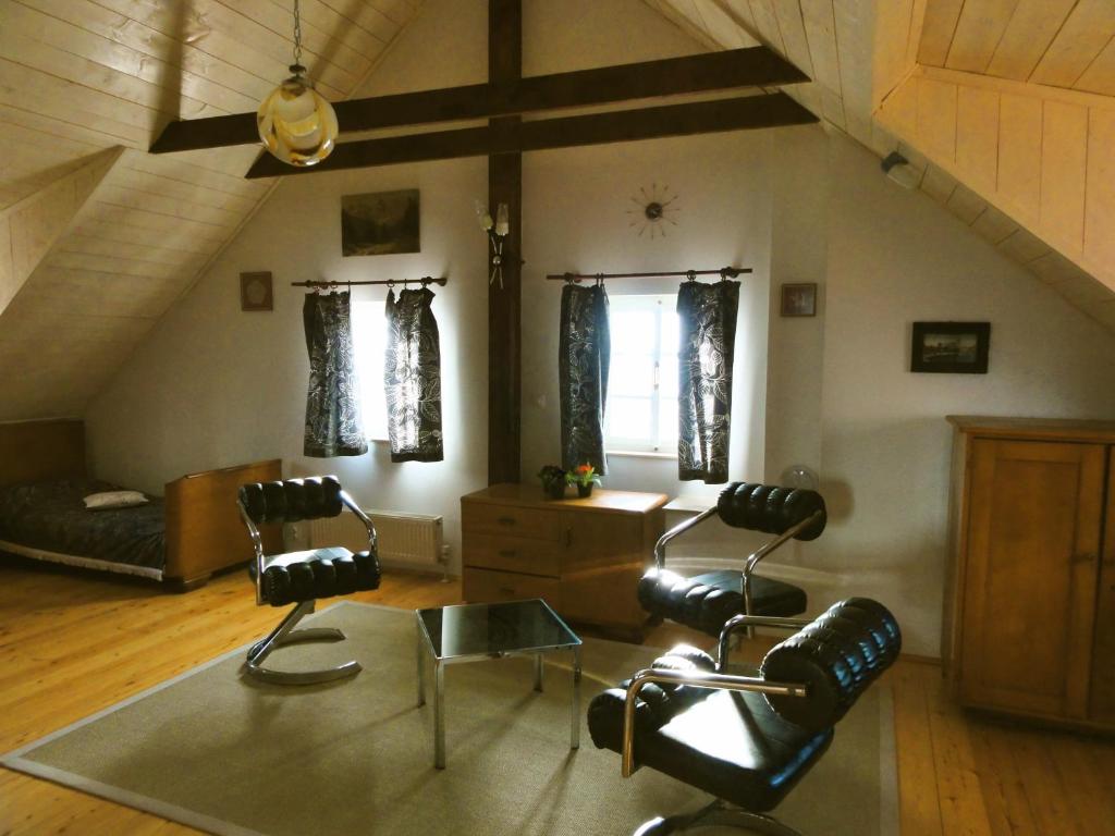 a living room with two chairs and a couch at Apartment Tagrajska in Ljubljana