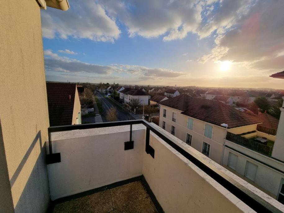 a balcony of a building with a view of a city at "bienvenue" appartement T2 meublé in Savigny-le-Temple
