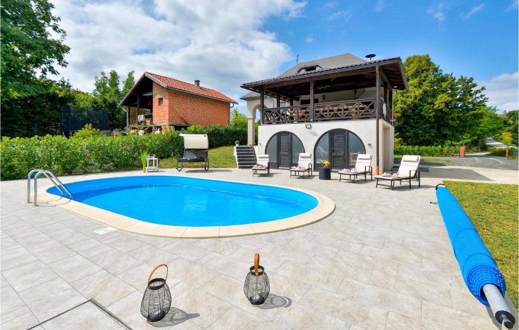 a swimming pool in a yard with a house at 3 Bedroom Nice Home In Rukljevina in Gornja Poljana