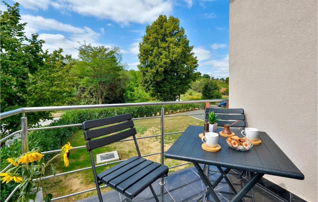 a table and chairs on a balcony with a view at 3 Bedroom Nice Home In Rukljevina in Gornja Poljana