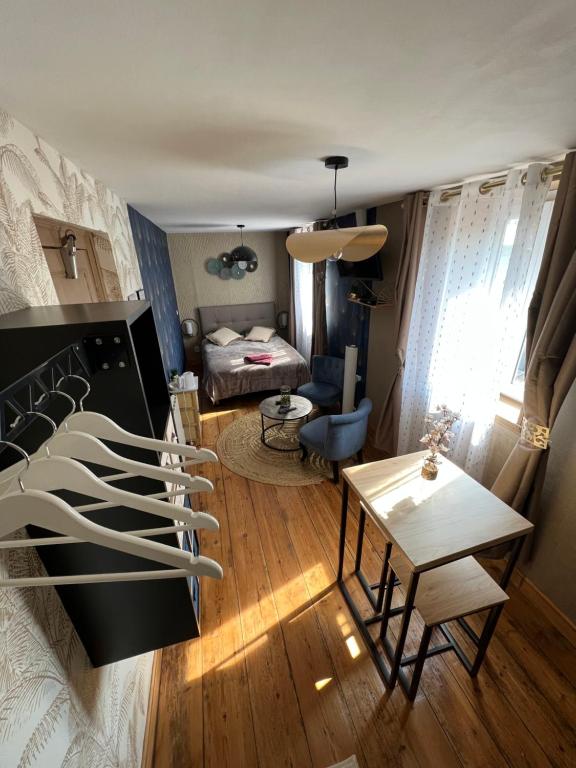 a living room with a bed and a table at Chambre D'hôte Villa Maurice in Étretat