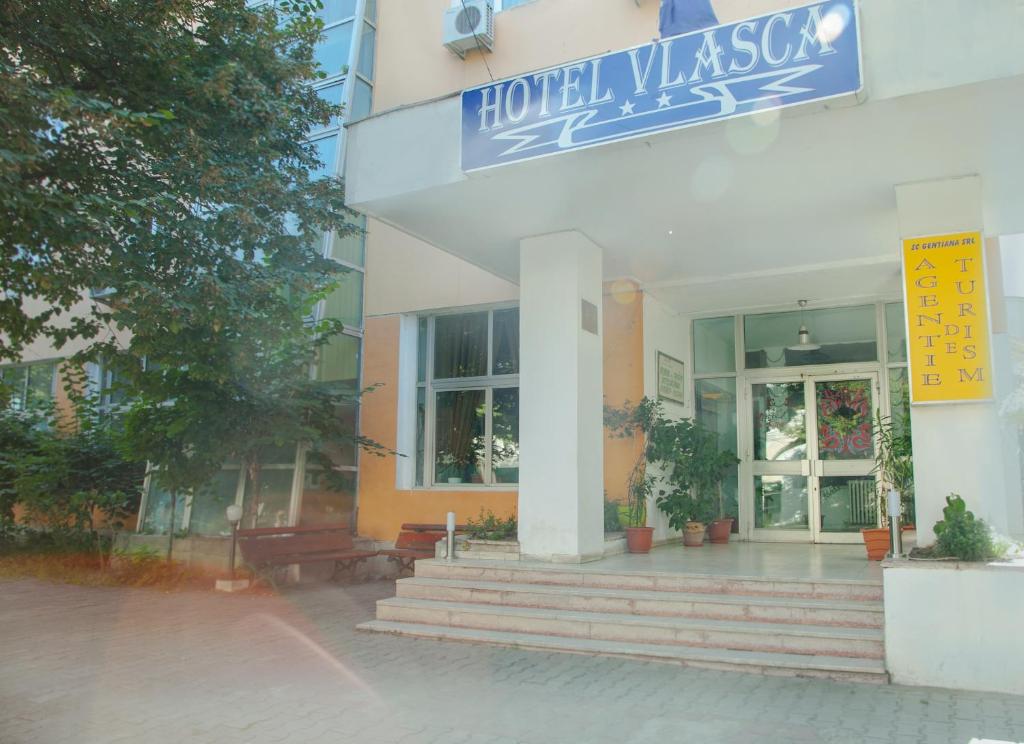 a hotel with a sign on the front of a building at Hotel Vlasca in Giurgiu