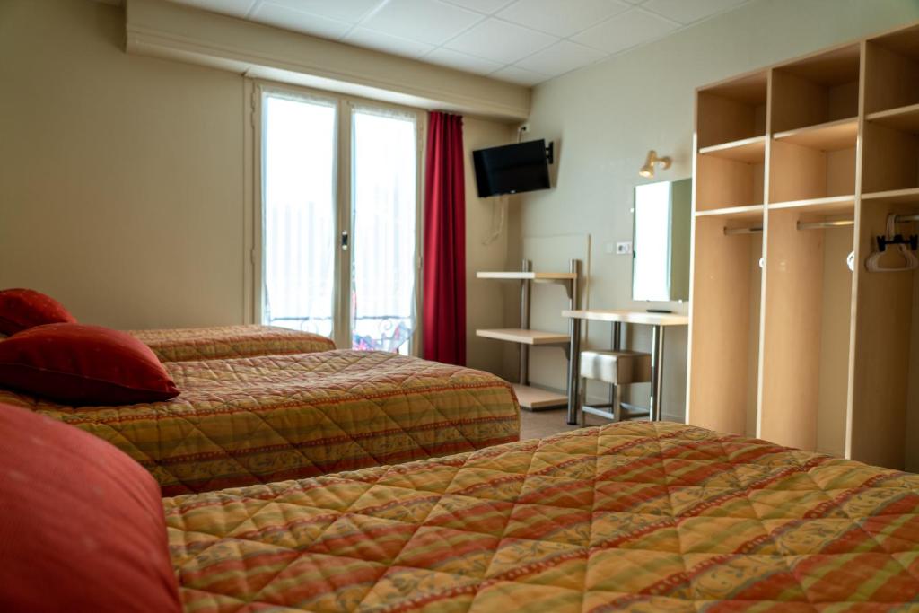 Postel nebo postele na pokoji v ubytování Au Primerose Hôtel