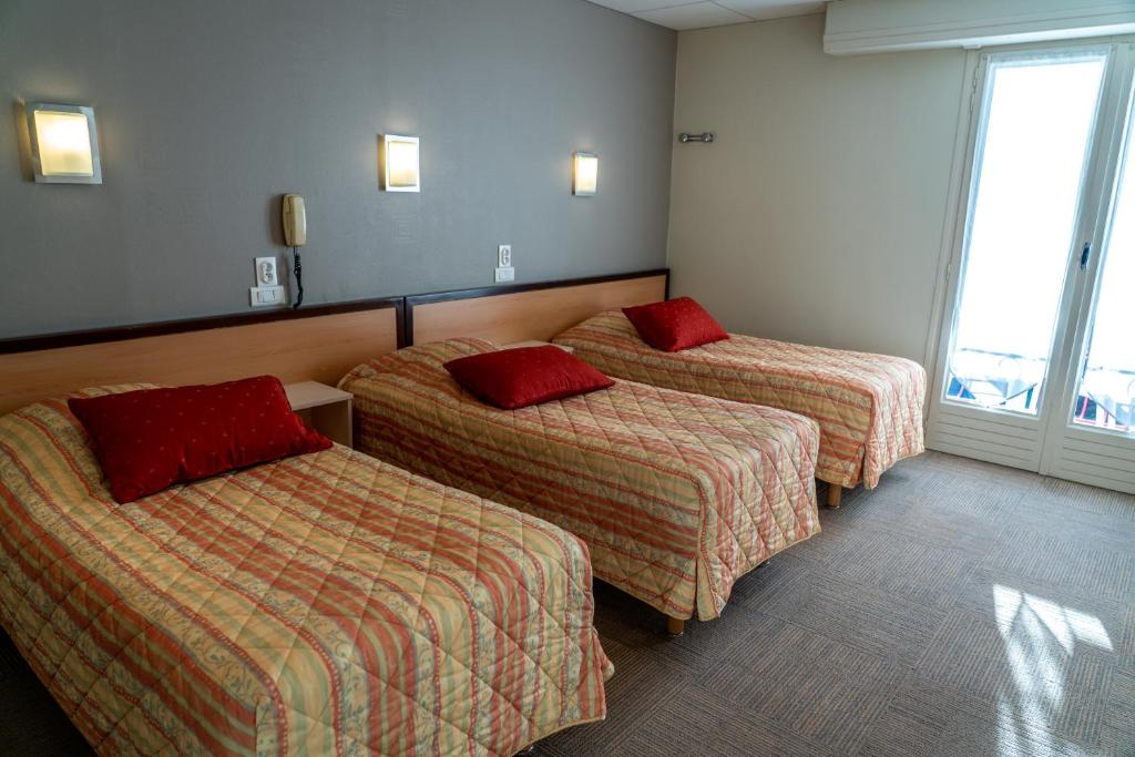 Postel nebo postele na pokoji v ubytování Au Primerose Hôtel