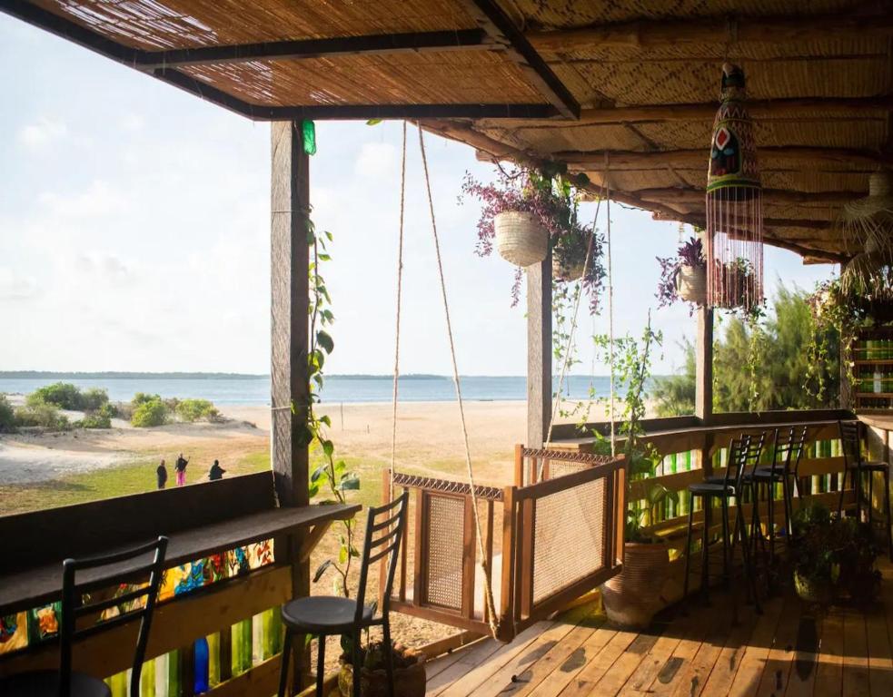a porch with a view of the beach at Kizingo Beach Eco Lodge in Lamu