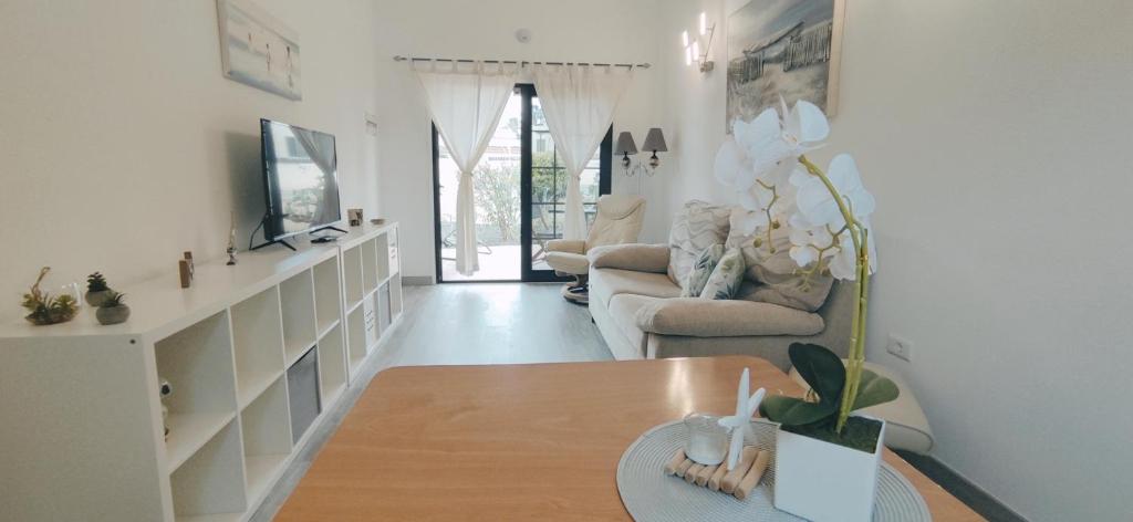 a living room with a couch and a table at CASA IVE ROMANTIC POOL in Caleta De Fuste