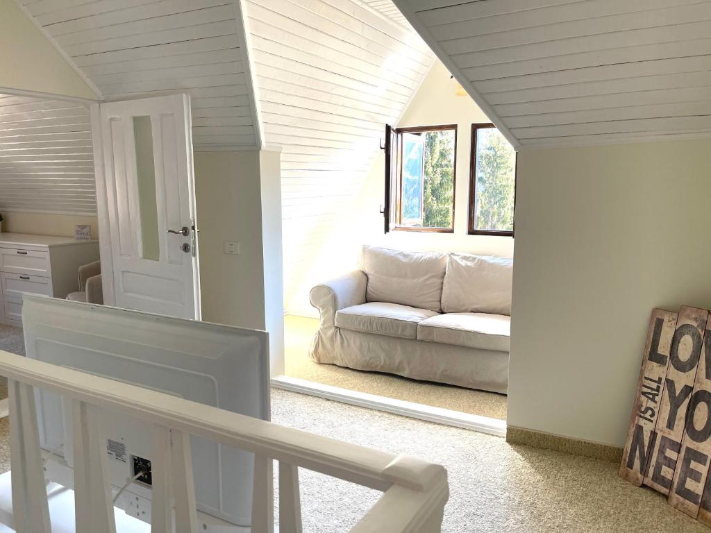 a living room with a couch and a window at The Nest in Sinaia