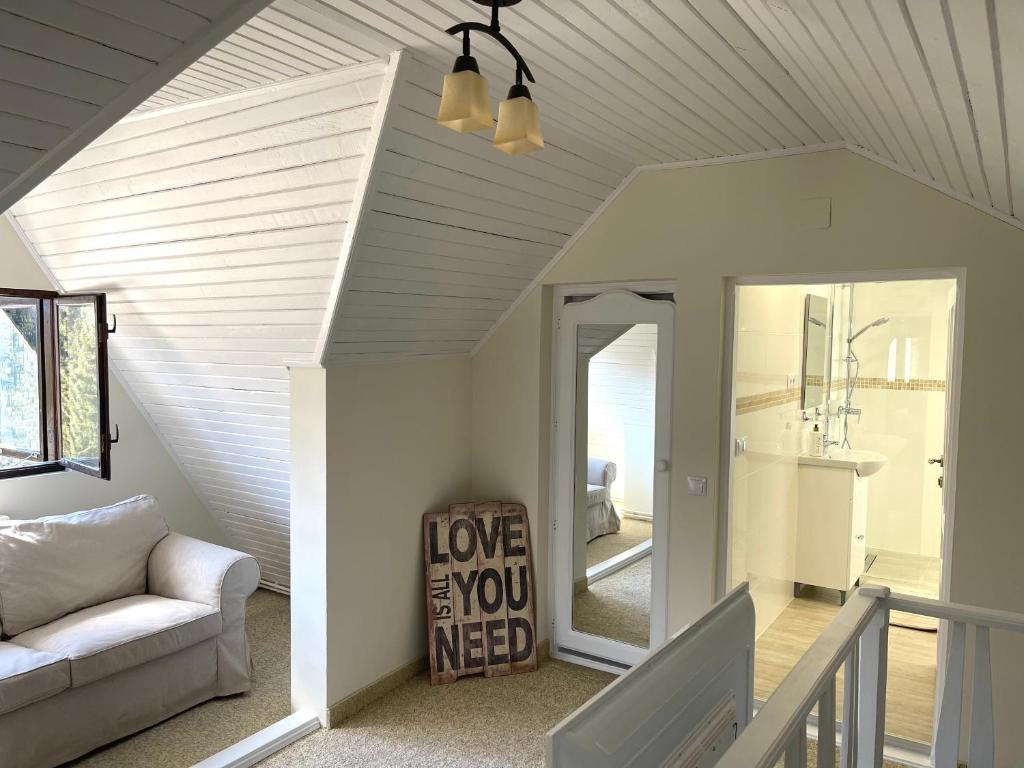 a living room with a couch and a mirror at The Nest in Sinaia