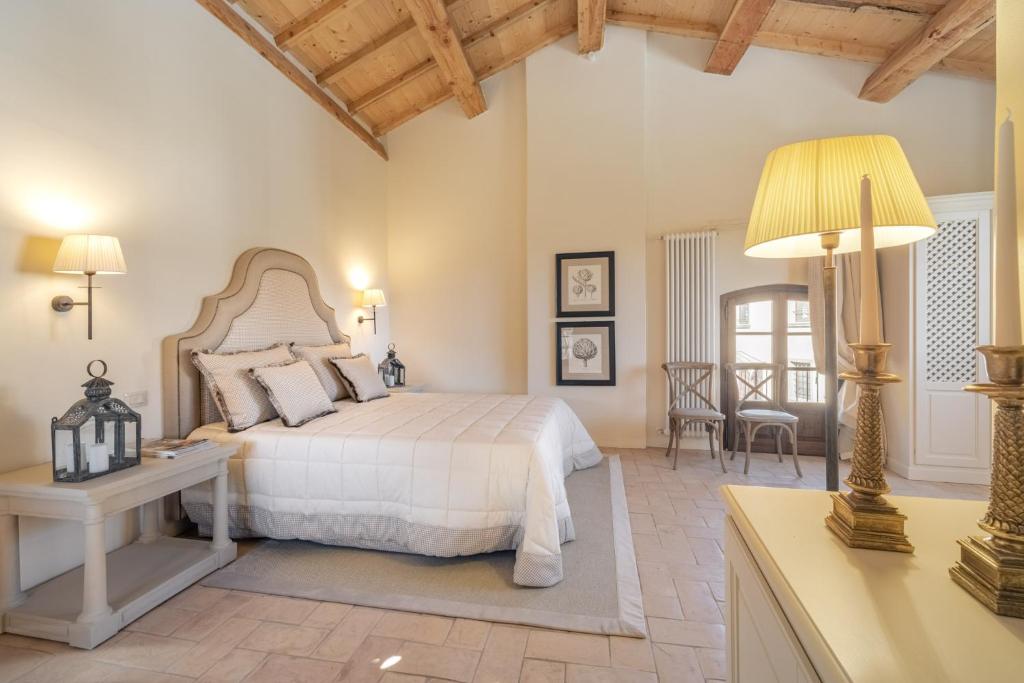a bedroom with a bed and a table with a lamp at Rivo della Corte in Pistoia