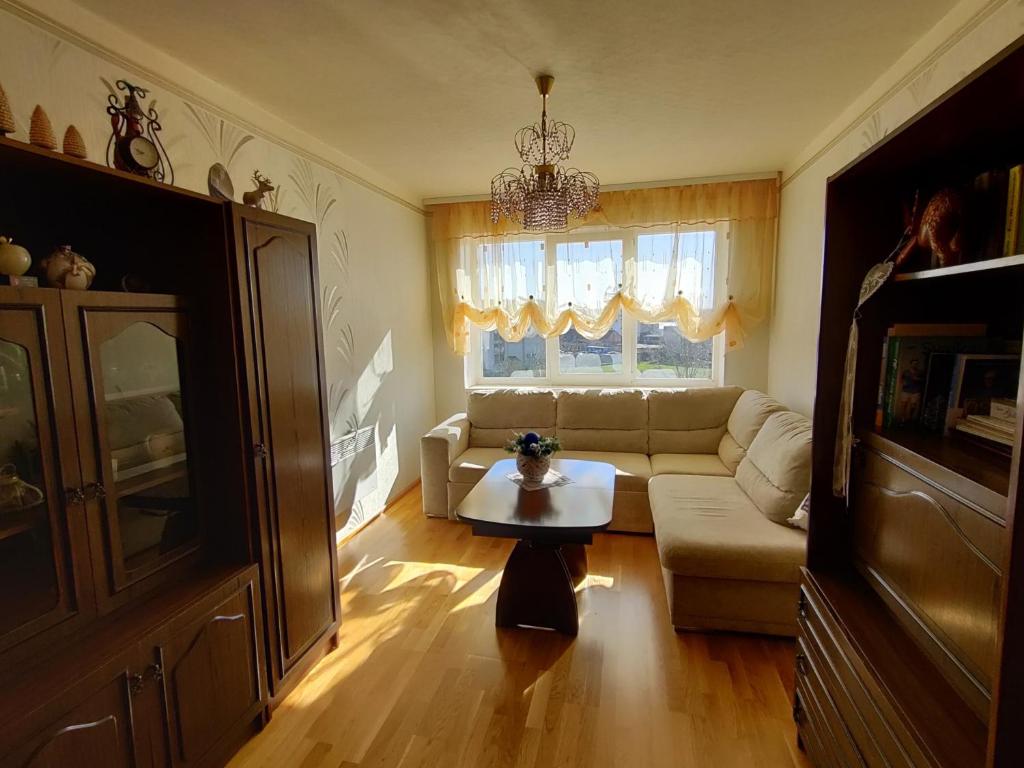 a living room with a couch and a table at Prie Masčio ežero in Telšiai