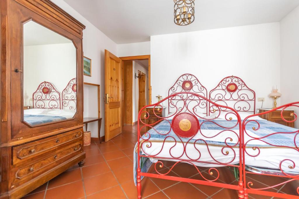 a bedroom with a bed and a dresser and a mirror at Casa Mulaz in Falcade