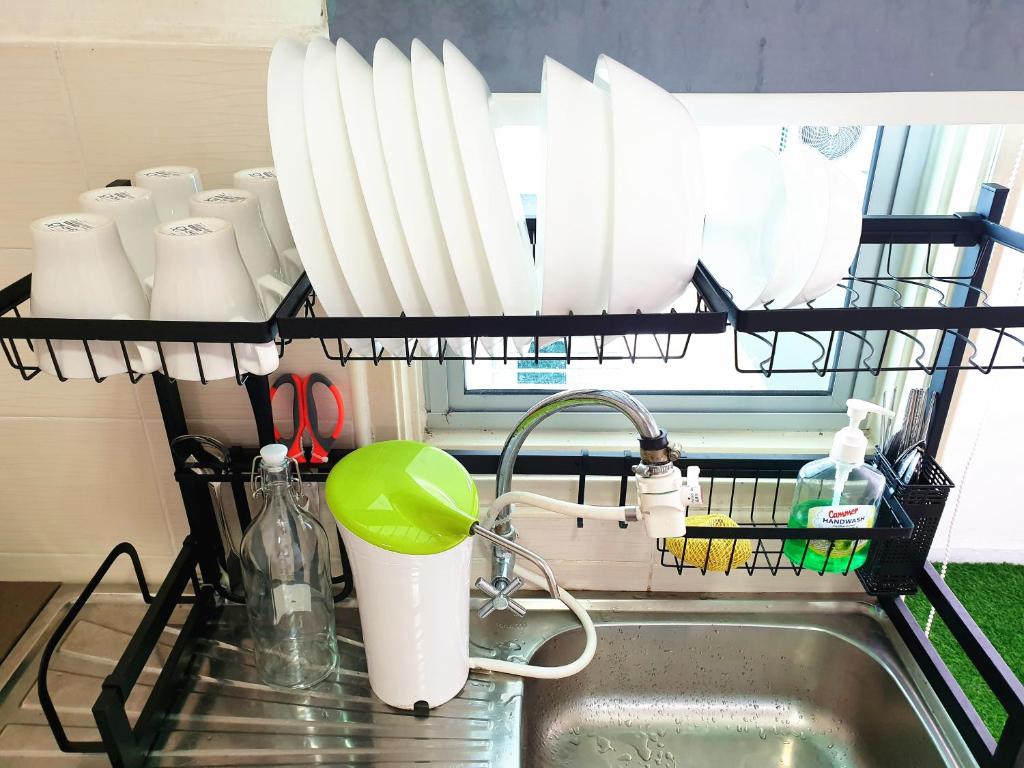 a kitchen sink with a dish drying rack above it at TuR11-Oppesite Pisa Stadium-1min-FoodCourt-MiniMarket in Bayan Lepas