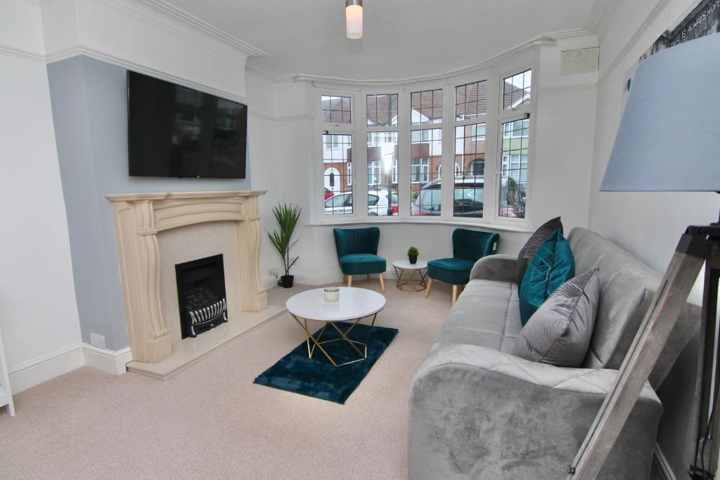 a living room with a couch and a fireplace at 3Bed Coventry Gem - The Perfect Home Away From Home in Coventry