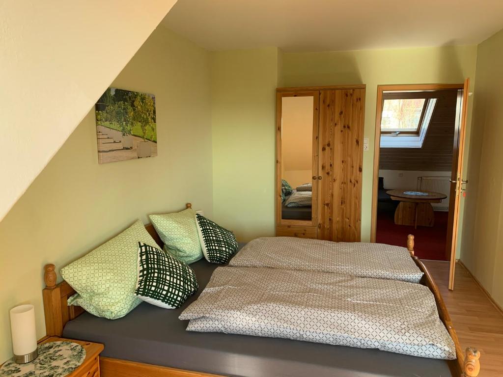 a bedroom with a bed with pillows on it at Ferienwohnung Buchenblick in Kassel