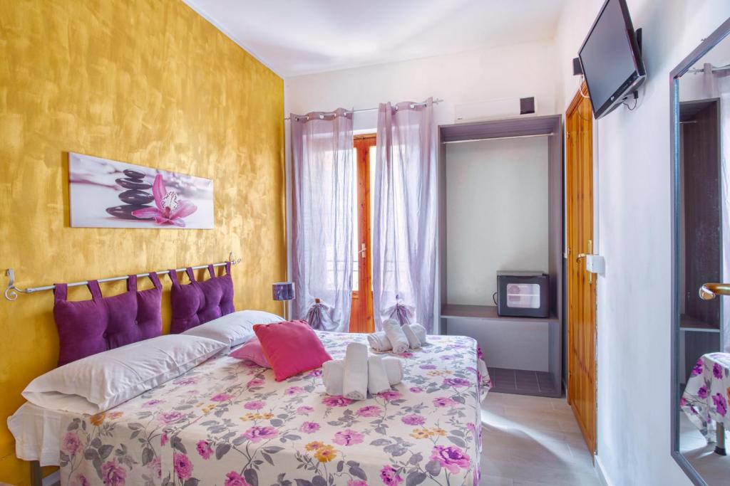 a bedroom with a bed and a tv in it at Daphne B&B in San Vito lo Capo