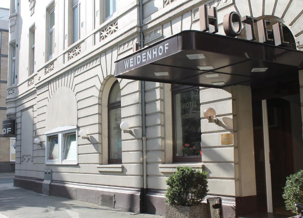 a store front of a building with a sign on it at Hotel Weidenhof in Düsseldorf