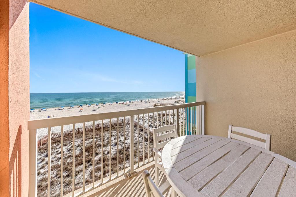 a balcony with a table and a view of the beach at Harbour Place 313 in Gulf Shores