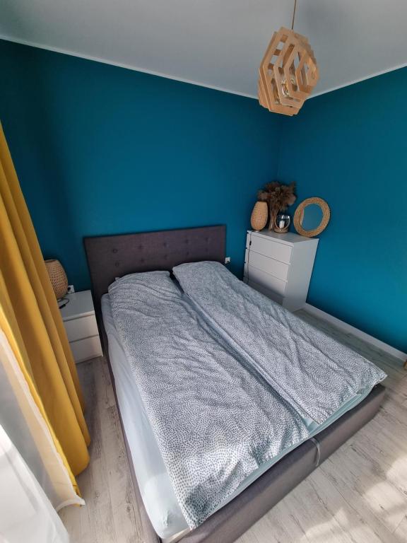 Posteľ alebo postele v izbe v ubytovaní Apartament Sosnowy Las