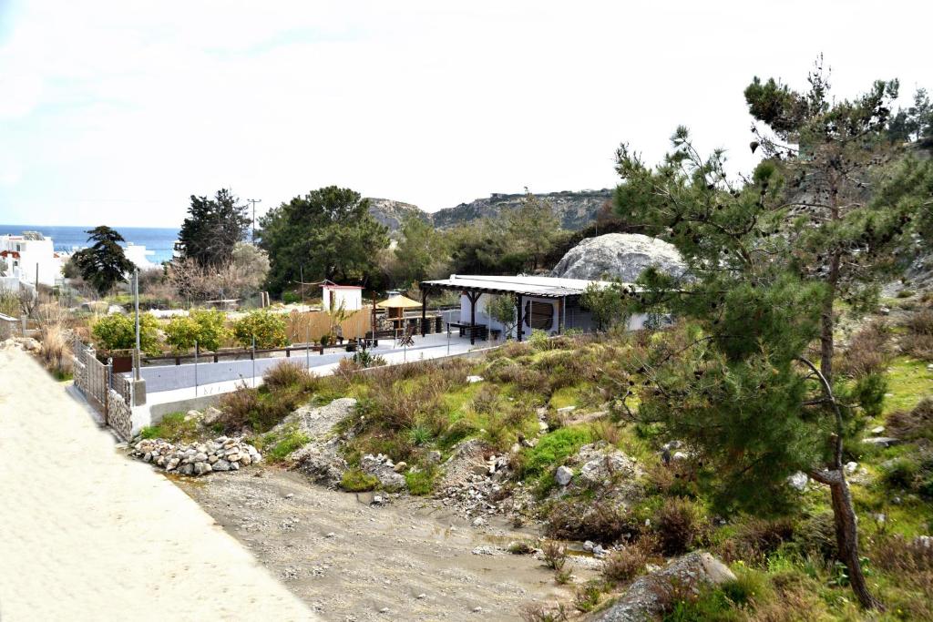 a house on a hill next to the ocean at PLUMERIA HOUSE in Archangelos