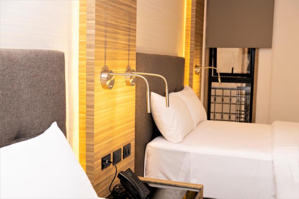 Postel nebo postele na pokoji v ubytování Hotel Plaza by Kavia