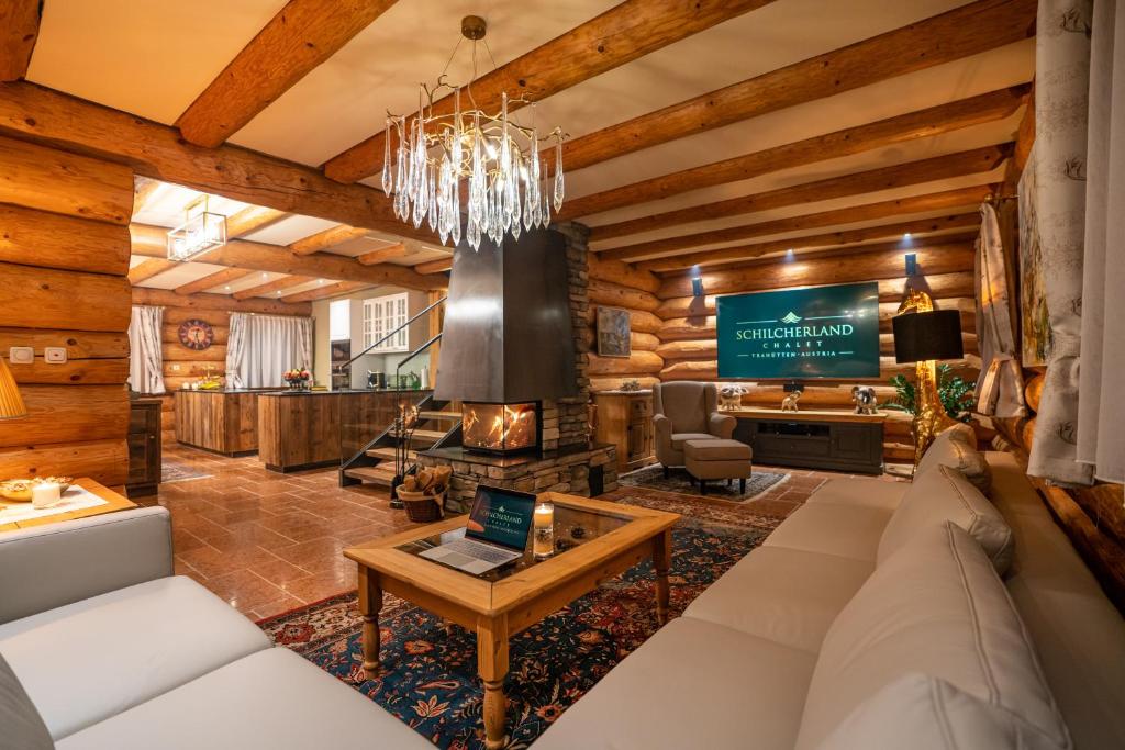 a living room with a couch and a fireplace at Schilcherland Chalet Südsteiermark in Trahütten