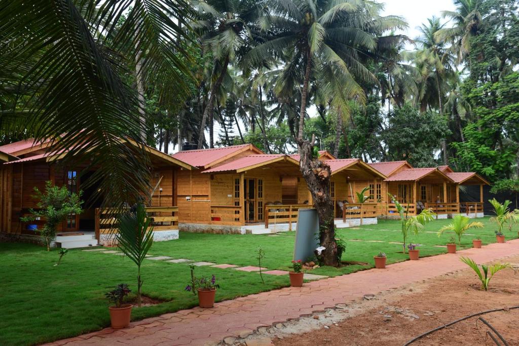 a row of houses with palm trees in front of them at Rockit Cafe & Stay in Palolem