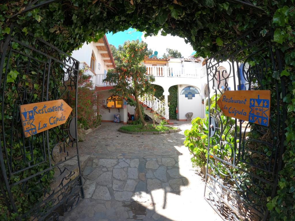 an entrance to a gate with signs on it at Hotel La Cupula in Copacabana