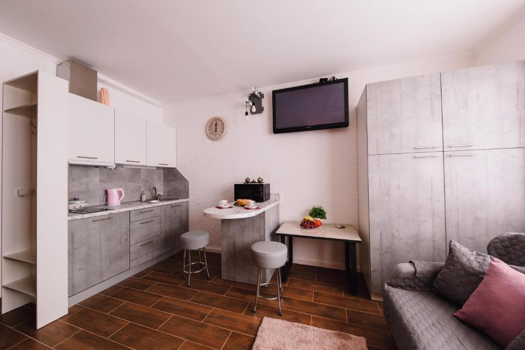 a kitchen with a couch and a table in a room at Найкраще розташування у місті Нові smart-квартири in Uzhhorod