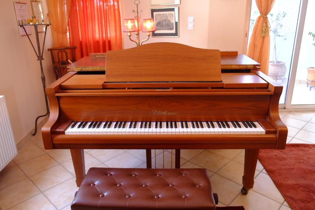 a wooden piano sitting in a living room at The Piano apartment in Perdika