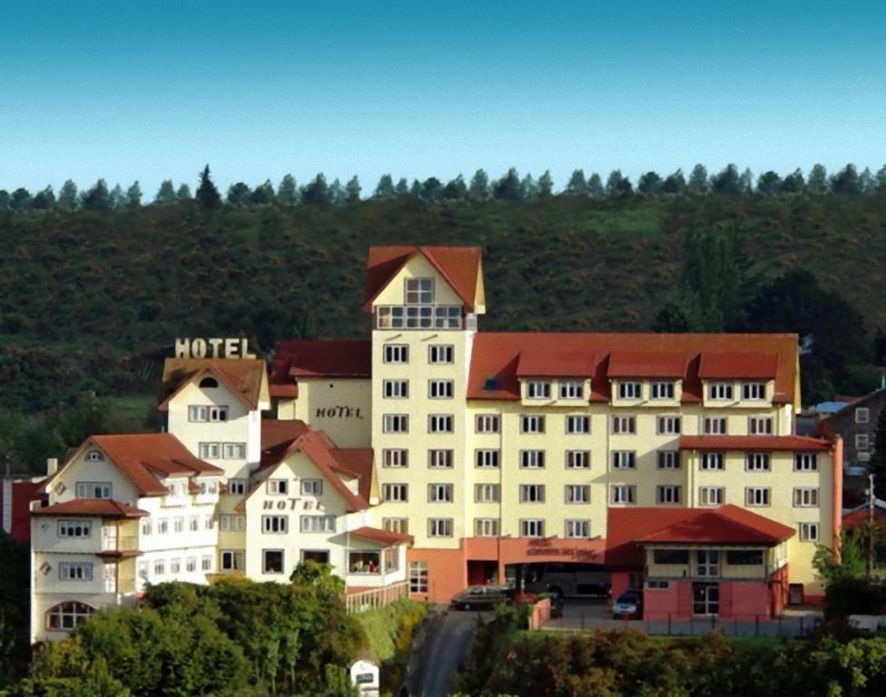 a large white building with a red roof at Park Inn by Radisson Puerto Varas in Puerto Varas