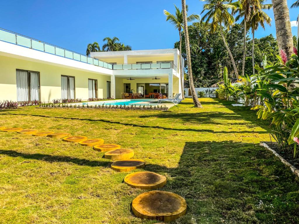 a house with stepping stones in the yard at Villa Calma, luxury for big groups at the beach with large pool in Las Terrenas