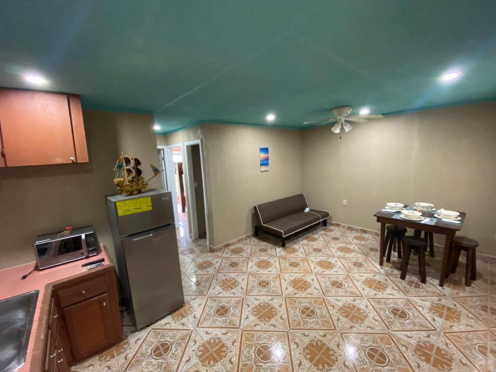 a kitchen with a couch and a table in a room at Forest View Apartment in Six Huts