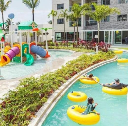 a water park with people riding on tubes in the water at Salinas Premium Resort in Salinópolis